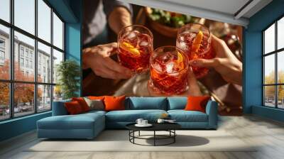 Two people toasting with drinks at a table. Wall mural