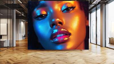 Woman with bright makeup and glowing eyes, staring intensely into the camera, against a dark background. Wall mural