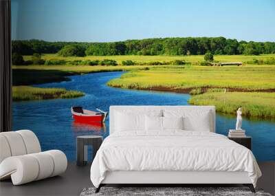 A e red canoe sites in a calm marsh Wall mural