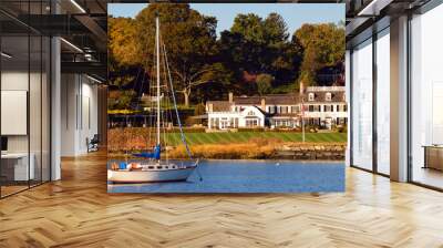 A rich life: A sailboat is moored at a luxury waterfront homes in Greenwich Connecticut, often considered one of the wealthiest towns in America Wall mural