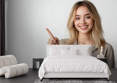 Blonde lady in a casual shirt pointing towards the upper right corner with a confident expression, studio shot with bright lighting. Ai generated Wall mural