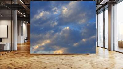 Blue, beautiful sky with  orange, grey, blue clouds Wall mural