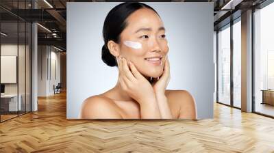 Asian woman, skincare cream and face makeup, sunscreen beauty product and luxury cosmetics wellness on studio background. Happy Japanese model, facial spf lotion and natural aesthetic dermatology Wall mural