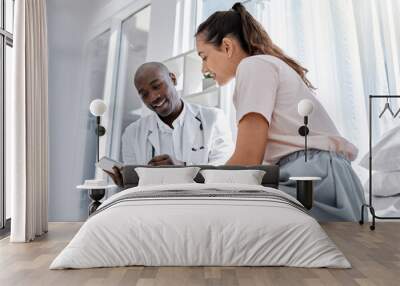 Doctor appointment or healthcare professional consulting a patient and showing her online medical results on a tablet. Medical worker or GP talking to a woman in a hospital or clinic Wall mural