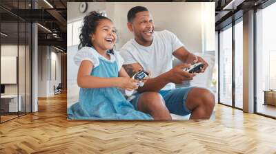 Im gonna beat you. Shot of a young man playing video games with his daughter at home. Wall mural