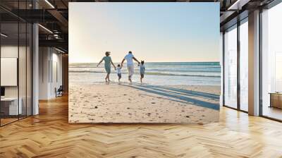 Lets go splish and splash. Rearview shot of a happy family walking towards the sea. Wall mural