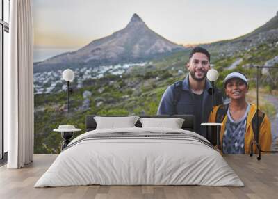 Spend time doing what you love with those you love. Shot of a young couple hiking on a mountain range outdoors. Wall mural