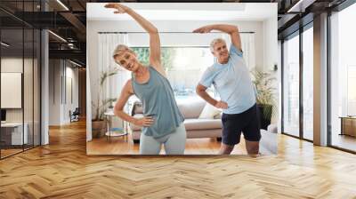 Stretching, yoga and fitness with a senior couple doing an exercise, workout or training at home. Health and wellness, lifestyle and active with a fit elderly man and woman exercising in a house Wall mural