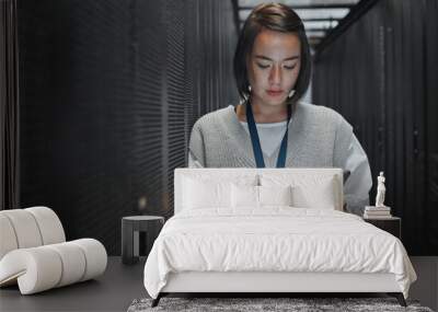 Tablet, server room and cloud computing with a programmer asian woman at work on a mainframe. Software, database and information technology with a female coder working alone on a cyber network Wall mural