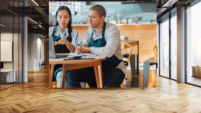 Cafe store owners planning budget, brainstorming coffee shop innovation strategy on laptop, taking notes. Startup entrepreneurs small business meeting, discuss restaurant financial goal and vision. Wall mural