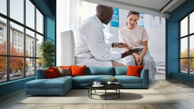 Doctor appointment or healthcare professional consulting a woman and explaining health using a tablet. A medical worker or GP talking to a patient and showing her scans or an online app in a hospital Wall mural