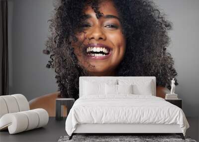 Face, hair care and beauty smile of black woman on gray studio background. Portrait, makeup and female model from Jamaica with beautiful, healthy head of hair and curls after spa cosmetics treatment Wall mural