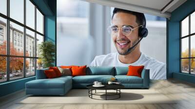 Flying through my workload. Shot of a young businessman working at his desk in his office. Wall mural