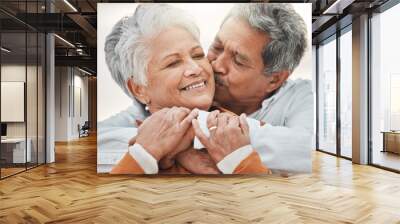 Happy elderly couple, hug and sunset with kiss on cheek, bonding and smile for romance, love and vacation. Senior man, woman and embrace with happiness, retirement and travel together for holiday Wall mural