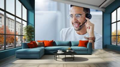 Hi there how may I be of service. Shot of a young businessman working at his desk in his office. Wall mural