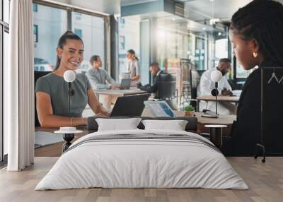 Portrait of a young digital marketing agency employee writing a proposal or a growth strategy for the company. Happy, excited and smiling business woman working in a busy office typing on a laptop Wall mural