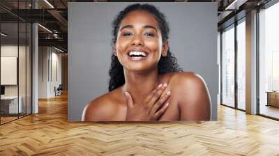 Skincare, beauty and portrait of a happy woman in a studio with a cosmetic makeup routine. Happiness, facial and natural face of a young model with a smile from Mexico isolated by a gray background. Wall mural