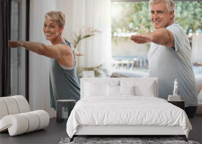 Yoga, fitness and senior couple doing home workout, training and wellness exercise in the living room together. Smile, old man and happy woman enjoying pilates and stretching in a healthy retirement Wall mural