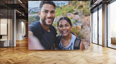 Youre my favourite person to hike with. Shot of a young couple taking photos while out on a hike in a mountain range outside. Wall mural