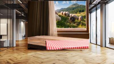 green trees and farm and shabby wooden table and red napkin and red vegetables Wall mural