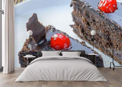 two chocolate brownie cakes with red berries on a white dish Wall mural