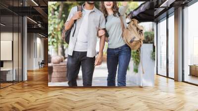 Beautiful happy couple summer portrait. Young joyful smiling woman and man in a city. Love, travel, tourism, students concept Wall mural