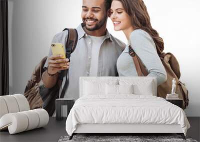 Beautiful happy young couple using smartphone isolated transparent PNG. Joyful smiling woman and man looking at mobile phone. Love, travel, tourism, students lifestyle concept Wall mural