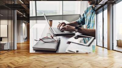 Businessman working on computer. Men using laptop and digital tablet in the office. Internet marketing, finance, business concept Wall mural