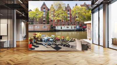 Charming canal with boat houses in Amsterdam old town, Netherlands. Popular travel destination and tourist attraction Wall mural