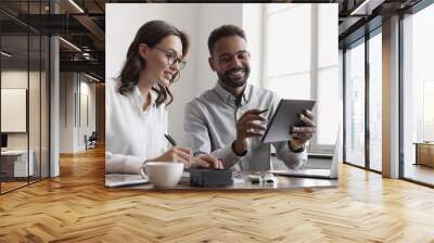 Coworkers working together in boardroom, brainstorming, discussing and analyzing business strategy. Young people professionals working in office, Colleagues using digital tablet in coworking. Wall mural