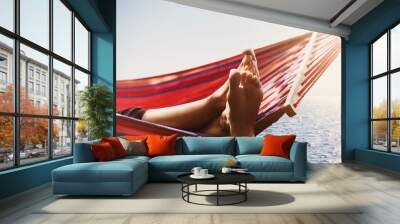 Enjoying life. Hammock above the sea, travel, summer fun and active lifestyle concept Wall mural