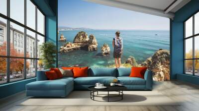 Female traveler looking at the sea in Lagos town, Algarve region, Portugal. Travel and active lifestyle concept Wall mural