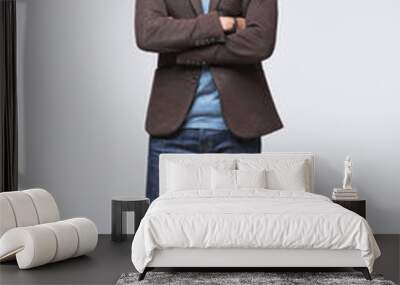 Full length studio portrait of handsome smiling young man isolated on gray background Wall mural