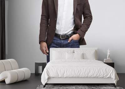 Full length studio portrait of handsome smiling young man isolated on gray background Wall mural