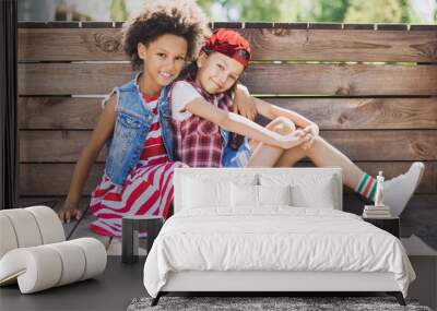 Happy little girlfriends playing in the city. Children having fun outdoors Wall mural