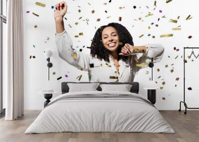 Happy woman with confetti falling everywhere on her isolated transparent PNG, Birthday celebration party or New Year eve celebrating concept Wall mural