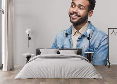 Portrait of handsome smiling young man looking away. Laughing joyful cheerful men studio shot. Isolated on gray background Wall mural