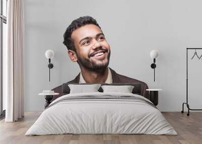 portrait of handsome smiling young man looking up. laughing joyful cheerful men studio shot. isolate Wall mural