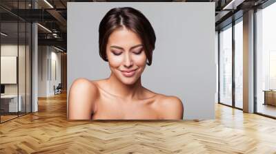 Studio portrait of a beautiful young woman with brown hair. Pretty model girl with perfect fresh clean skin. Beauty and skin care concept Wall mural