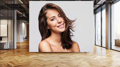 Studio portrait of a beautiful young woman with long brunette hair. Pretty spa model girl with perfect fresh clean skin. Youth and skin care concept Wall mural