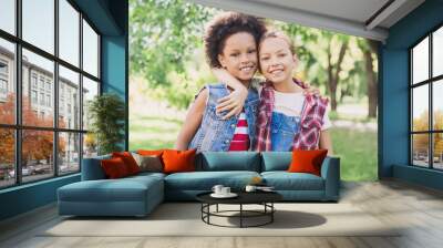 Two little girls hugging in the park Wall mural