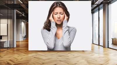 Young beautiful woman has headache, isolated on gray background Wall mural