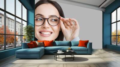 Young beautiful woman isolated portrait. Student girl wearing glasses closeup studio shot, Young businesswoman smiling indoor, People, beauty, student lifestyle, business concept Wall mural