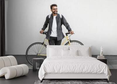 Young handsome man with bike over white wall background in a city, Smiling student man with bicycle smiling outdoor, Modern healthy lifestyle, travel, casual business concept Wall mural