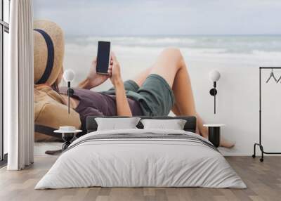 Young woman lying with smart phone on beach panoramic banner. Relaxation and freelance concept	 Wall mural