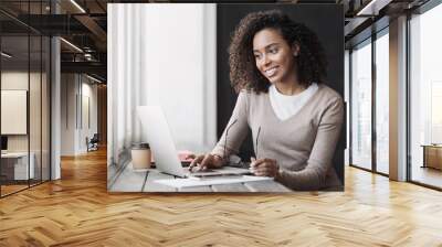 Young woman using laptop computer at office. Student girl working at home. Work or study from home, freelance, business, lifestyle concept. Wall mural