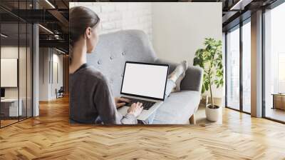 Young woman working at home, Student girl using laptop computer with blank empty screen, online shopping, work or studying from home, freelance, online learning, distance education concept Wall mural