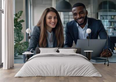 High-resolution photorealistic image of two diverse business colleagues smiling and reviewing financial reports at a laptop in a modern, clean office. Their collaboration and engagement are Wall mural