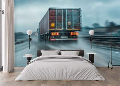 Rear view of a transport truck accelerating on a wet road, with motion blur in the background adding drama, representing fast and reliable freight services Wall mural