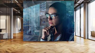 Close up of a beautiful girl with glasses while she is working with a futuristic computer with holograms. Concept: Future, technology, work Wall mural